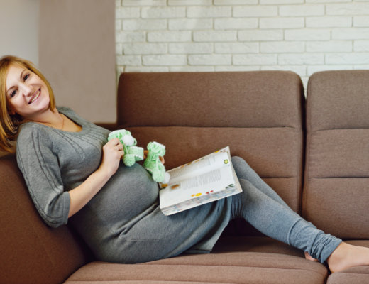 baby freebies on couch next to pregnant woman